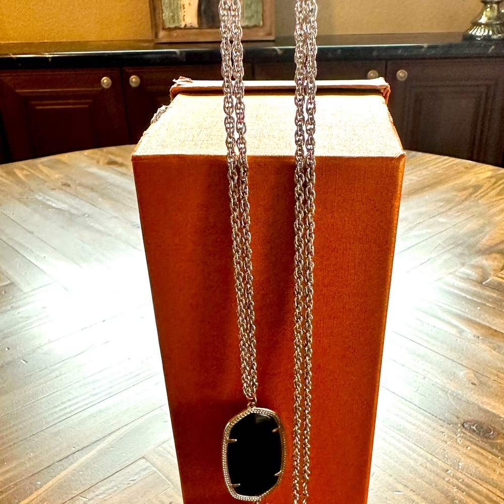 Kendra Scott Silver necklace with black pendant. The chain is 32"